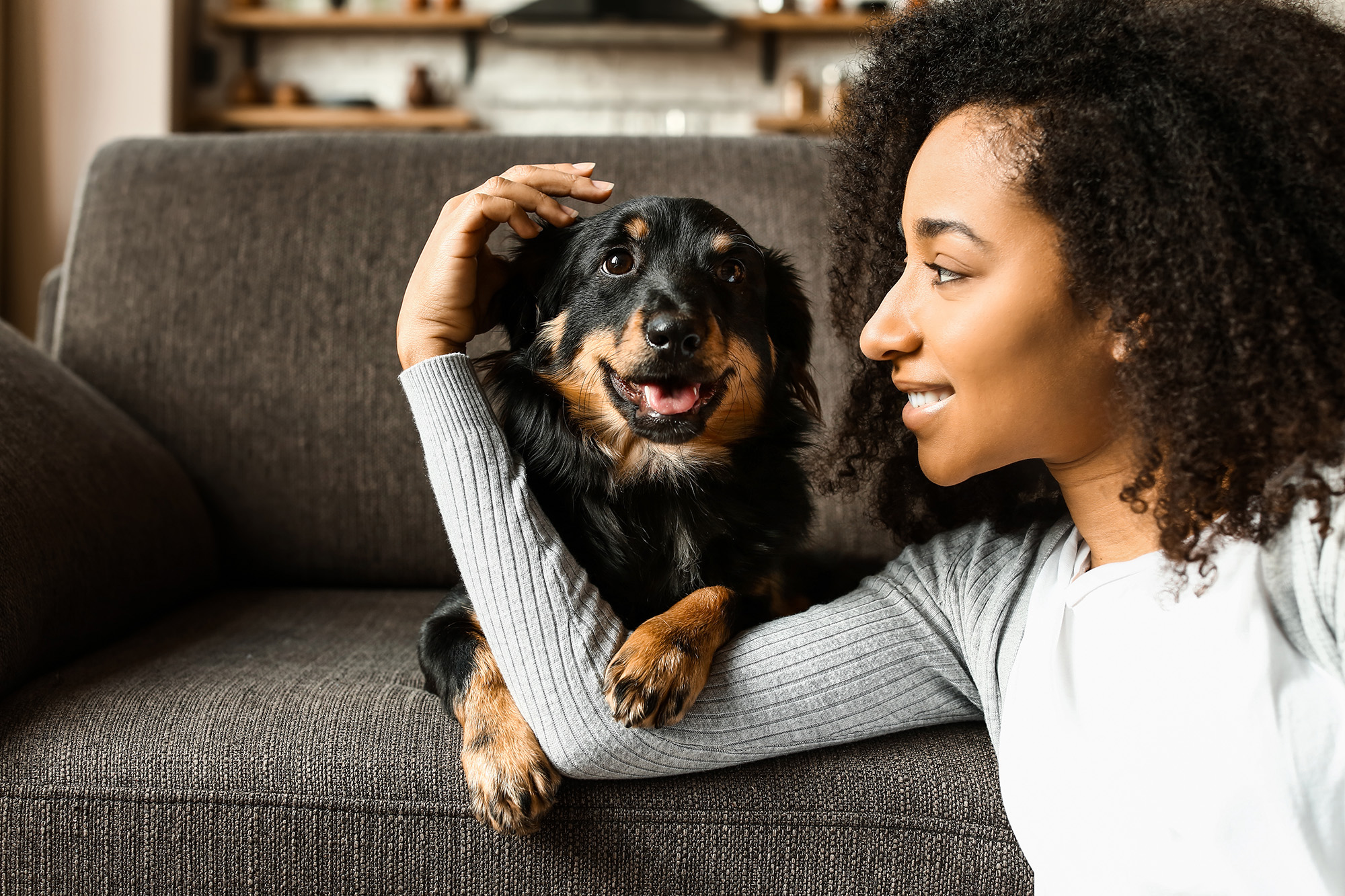 Woman with a dog at home.