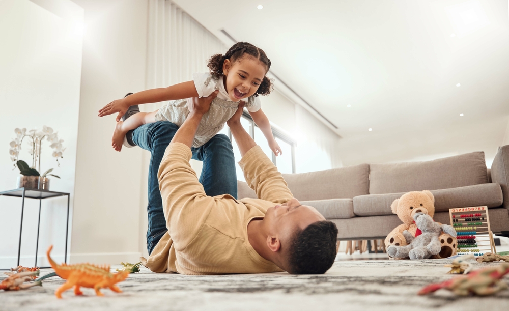 A father playing with his daughter.